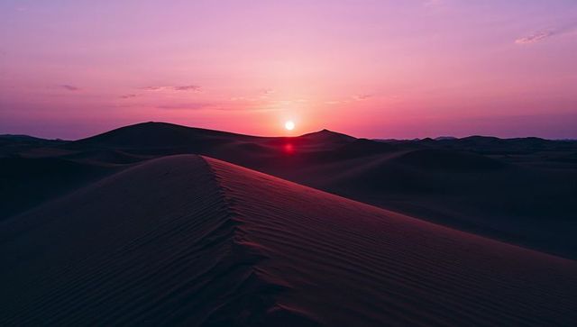 Tranquil desert sunset with majestic sand dune in vivid colors