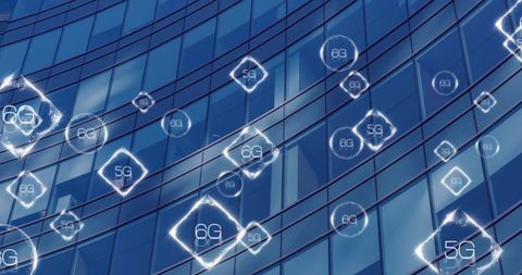 5G and 6G Connectivity Symbols on Reflective Skyscraper