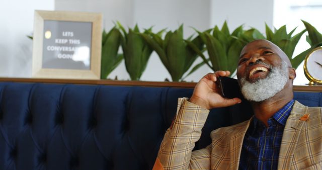 Senior African American Man Laughing on Phone in Modern Cafe - Download Free Stock Images Pikwizard.com