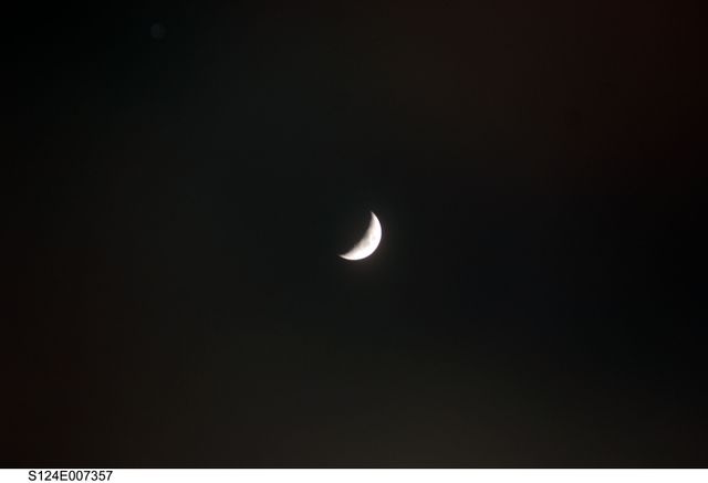 S124-E-007357 (8 June 2008) --- A crescent moon is featured in this image photographed by a STS-124 crewmember while Space Shuttle Discovery is docked with the International Space Station.