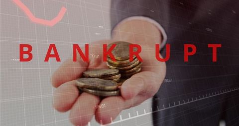Holding out coins over falling stock chart with bold bankrupt text signaling insolvency
