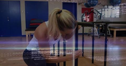 Athletic woman engaging in physical therapy with parallel bars