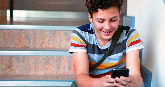 Teenager Smiling and Using Smartphone on Staircase - Download Free Stock Images Pikwizard.com