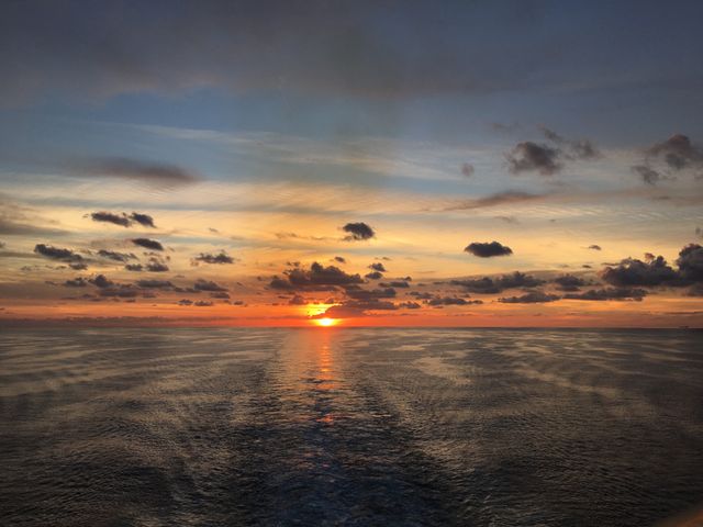 Stunning Ocean Sunset with Dramatic Sky and Calm Sea - Download Free Stock Photos Pikwizard.com