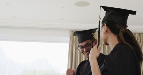 Graduating couple celebrating academic achievement together