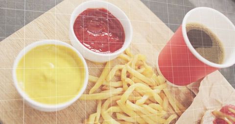 Serving thin french fries with ketchup, mustard and coffee in red cup on wooden board