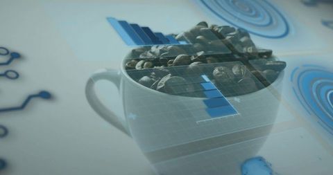Projecting blue data overlay onto coffee cup filled with roasted beans