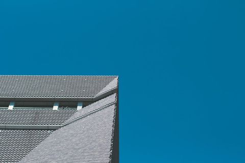 Modern Building Roof Against Clear Blue Sky Backdrop