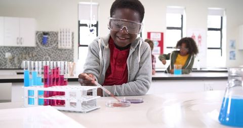 Children Experimenting in Science Laboratory with Pipettes and Test Tubes