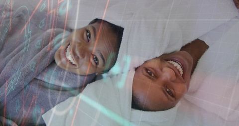 Smiling mother and daughter relaxing in spa robes and towel wraps, bonding and self-care