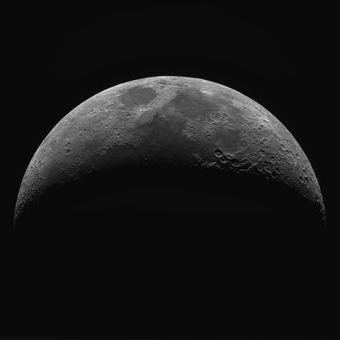 Captivating close-up of waning crescent moon surface