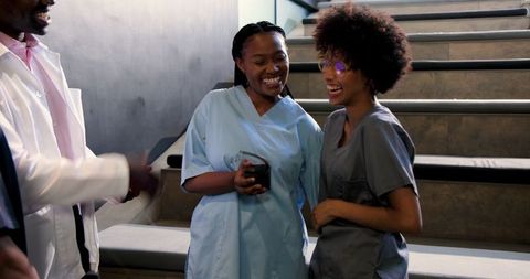 Diverse Medical Team Congratulating Female Doctor in Hospital