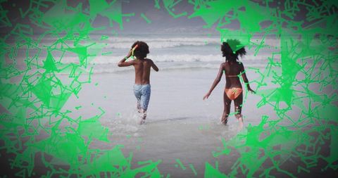 Siblings running into surf with neon green geometric overlay summer beach motion