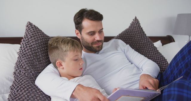 Father Reading Bedtime Story to Son in Comfortable Bedroom - Download Free Stock Images Pikwizard.com