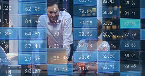 Business Team Processing Financial Data on Laptop in Modern Office