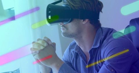 Man Engaging with Virtual Reality Headset Overlayed with Color Streaks - Download Free Stock Images Pikwizard.com