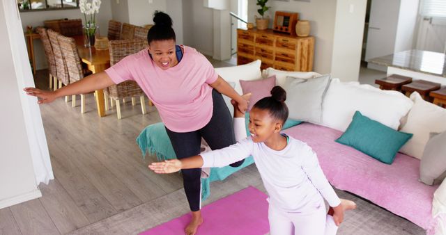 Mother and daughter practicing yoga in living room for wellness and bond - Download Free Stock Images Pikwizard.com