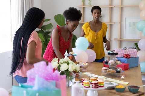 Friends Arranging Cupcakes for Celebration Gathering at Home