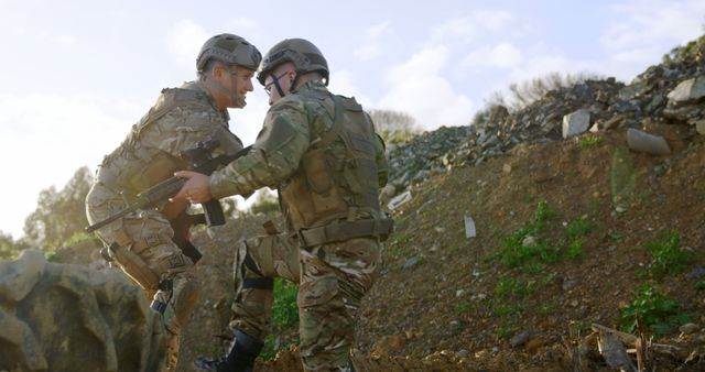 Two Soldiers Aiding Each Other During Military Training in Rugged Terrain - Download Free Stock Images Pikwizard.com