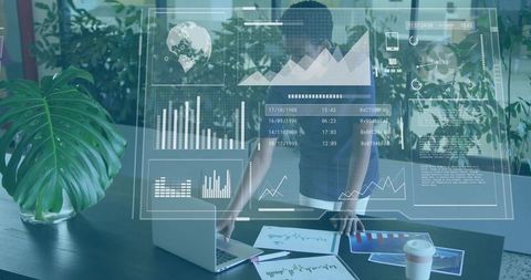 Businesswoman analyzing augmented reality data dashboards over laptop amid green workspace