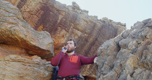 Man Drinking Water While Rock Climbing in Rocky Mountains - Download Free Stock Images Pikwizard.com