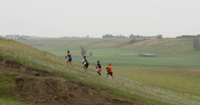 Group of Athletes Running Uphill in Rural Landscape - Download Free Stock Images Pikwizard.com