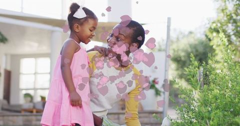 Joyful Mother-Daughter Bonding While Gardening Outdoors