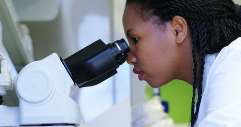 Focused African Scientist Using Microscope in Modern Laboratory - Download Free Stock Images Pikwizard.com