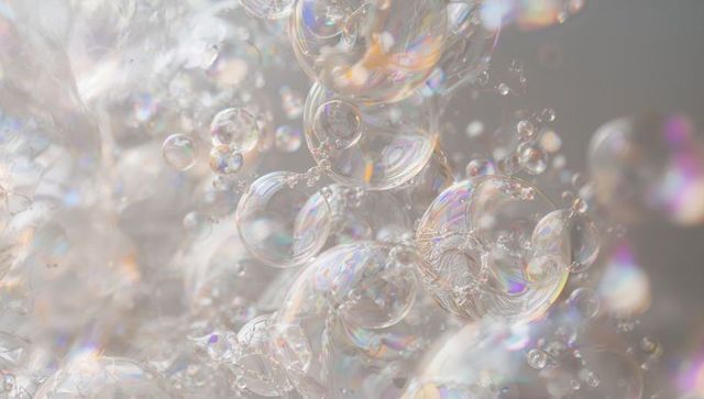 Iridescent soap bubbles clustering in soft pastel macro with ethereal prismatic reflections