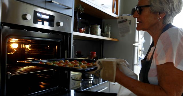 Senior Woman Baking Cookies at Modern Kitchen Oven - Download Free Stock Images Pikwizard.com