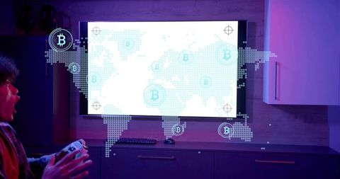 Young gamer reacting to bitcoin world map on tv while holding gamepad in neon home setup