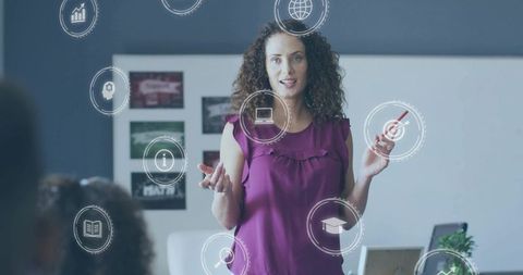 Woman presenting business training with infographic icons pointing at whiteboard
