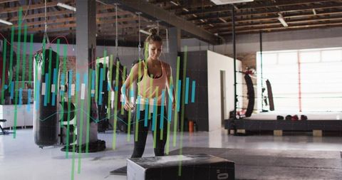 Woman preparing for plyo box jump in industrial gym with fitness analytics overlays