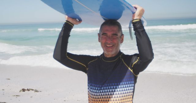 Portrait of happy senior caucasian man holding surfboard on beach - Download Free Stock Photos Pikwizard.com