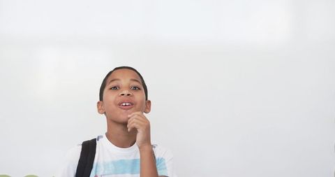 Young student pondering ideas in classroom