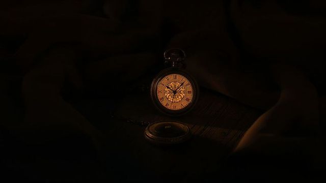 Glowing antique pocket watch with exposed gears and vintage charm