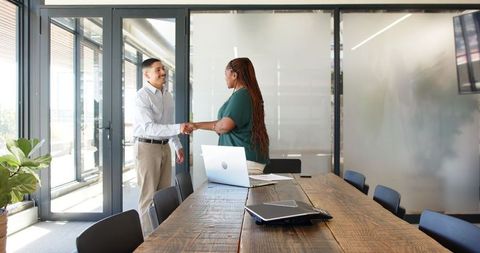 Friendly business interaction in modern meeting room