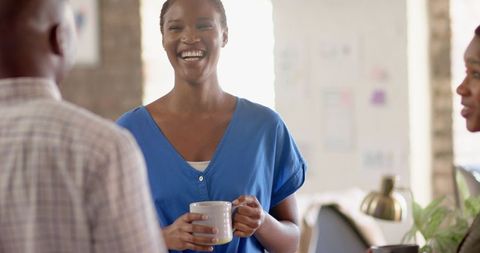 Smiling Professional Enjoying Coffee Break in Office Environment