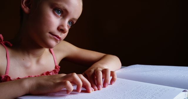 Young Girl Reading Braille Book with Focus and Curiosity - Download Free Stock Images Pikwizard.com