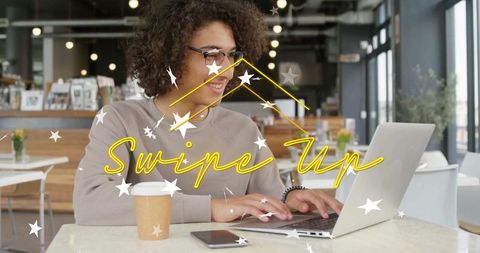 Woman Working with Laptop in Cozy Coffee Shop Environment