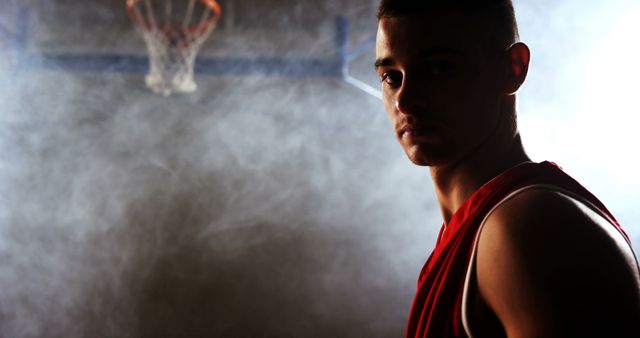 Intense Basketball Player with Hoop Background - Download Free Stock Images Pikwizard.com