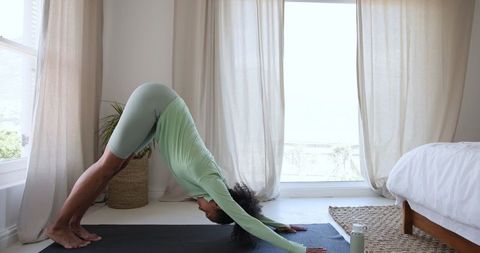 African American Woman Practicing Yoga in Bright Serene Room