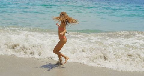 Woman Spinning Enjoying Sunny Beach Day - Download Free Stock Images Pikwizard.com