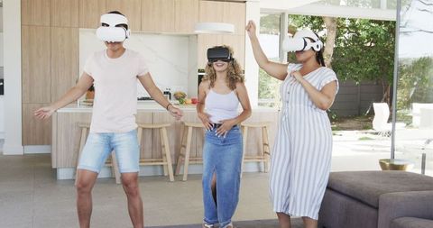 Diverse Friends Immersed in Virtual Reality Experience at Home