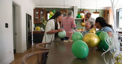 Diverse senior friends preparing for celebratory party