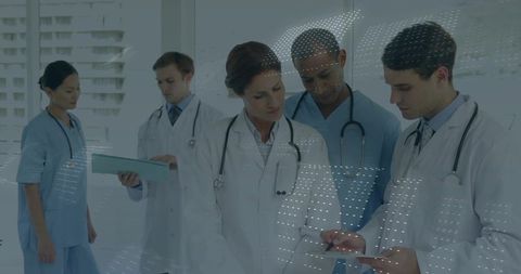 Medical Professionals Discussing Patient Data in Hospital Corridor