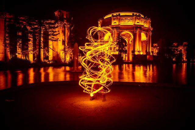Capturing the beauty of an illuminated architectural structure with creative light painting. Perfect for showcasing creativity and art, night photography themes, or cityscape art exhibit designs.