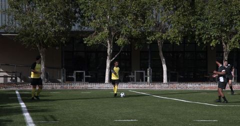 Teen Soccer Players Practicing Teamwork on School Field