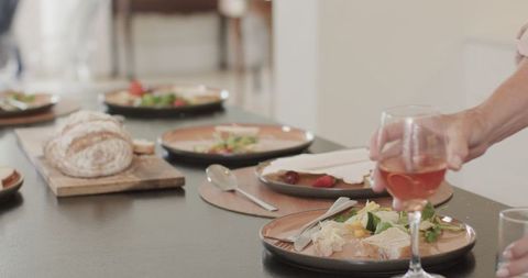 Family Gathering Serving Meal Around Dining Table