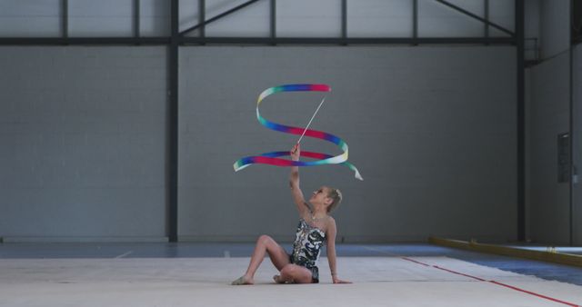 Young Rhythmic Gymnast Performing with Ribbon in Indoor Sports Hall - Download Free Stock Images Pikwizard.com
